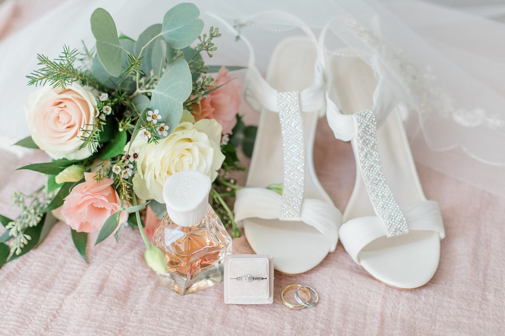 wedding shoes, wedding rings, and bouquet of florals all together for a wedding details photo