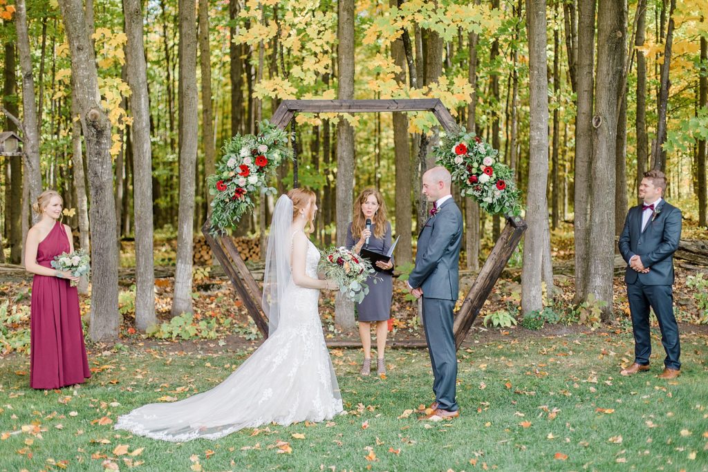bride and groom standing at the altar of their petite backyard wedding