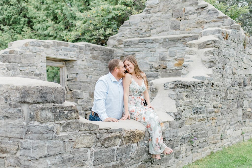 couple sitting on the historical ruins of pinheys point for a picture