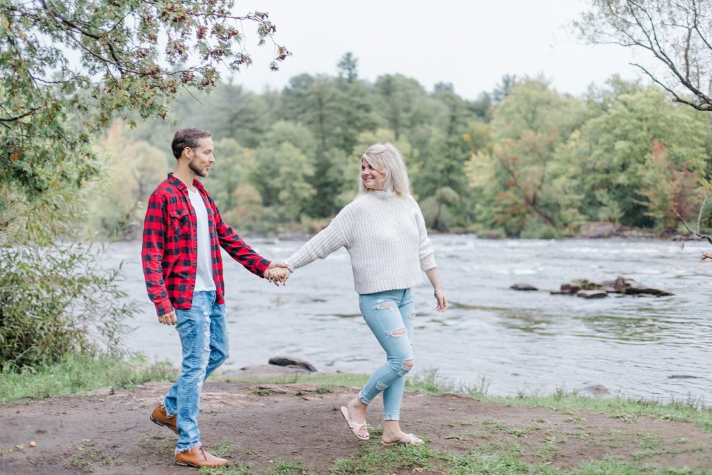 couple going for a walk by the blakeney rapids in almonte