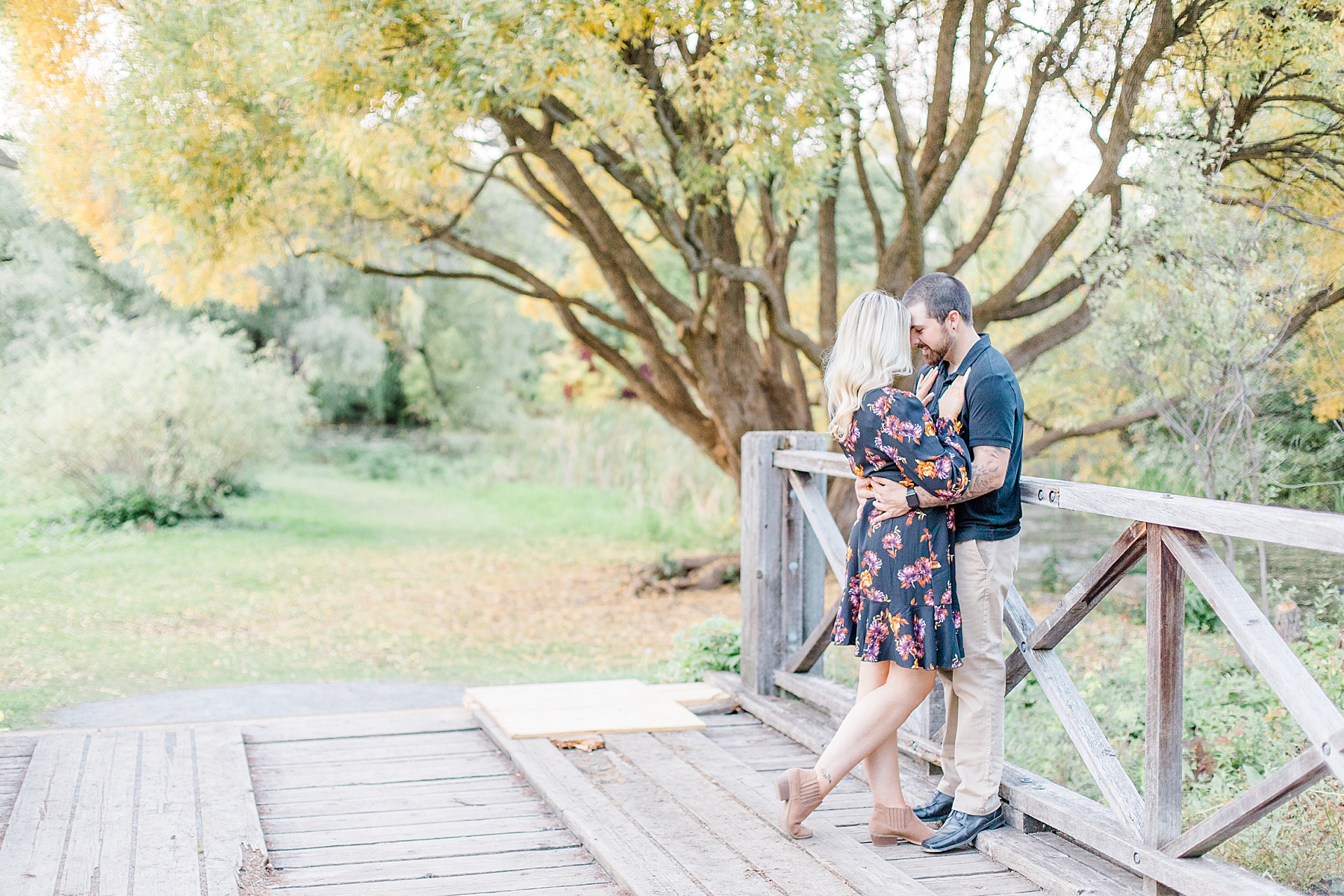 couple standing together on bridge at dominion arboretum