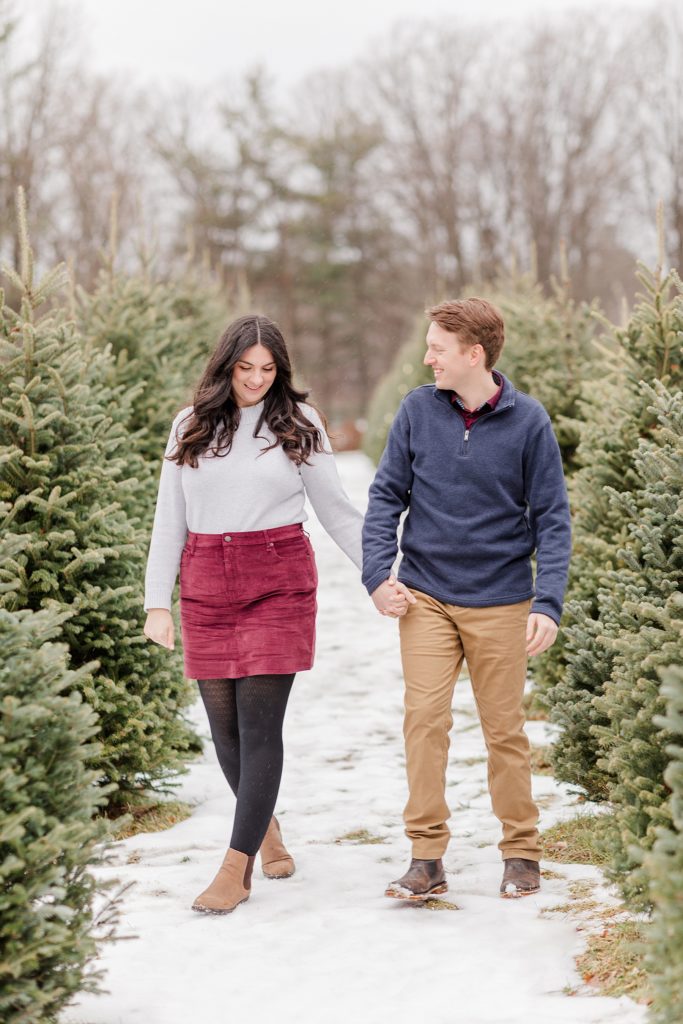 couple looking for tree at the christmas tree farm