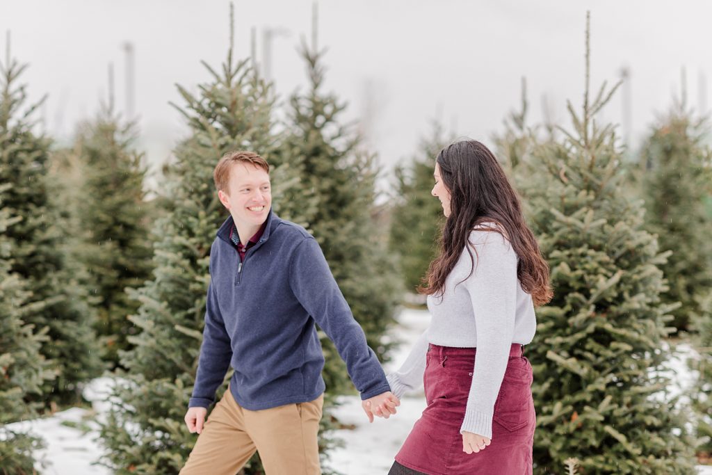 couple walking at the christmas tree farm