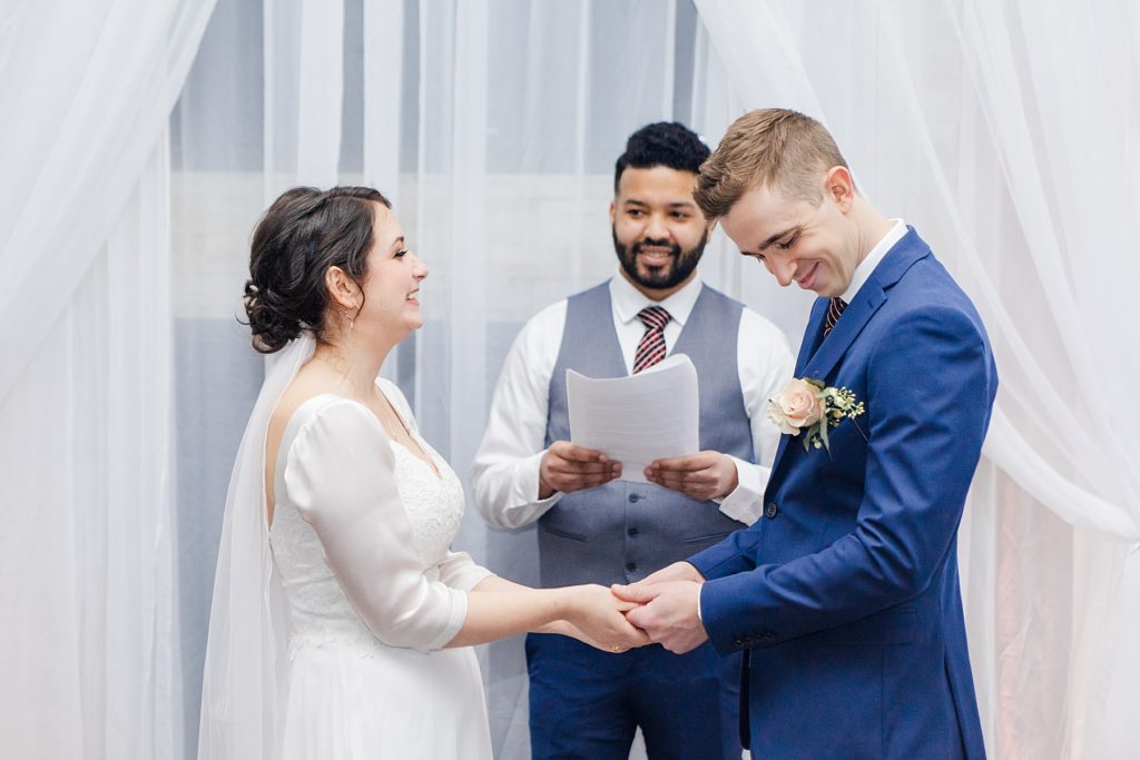 Bride and groom laughing while saying their vows during ceremony at NeXT Restaurant wedding