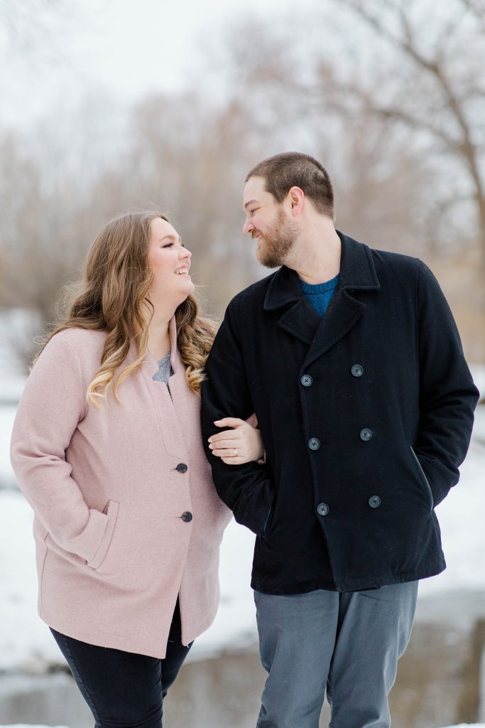 couple looking at eachother with arms linked at ottawa engagement session