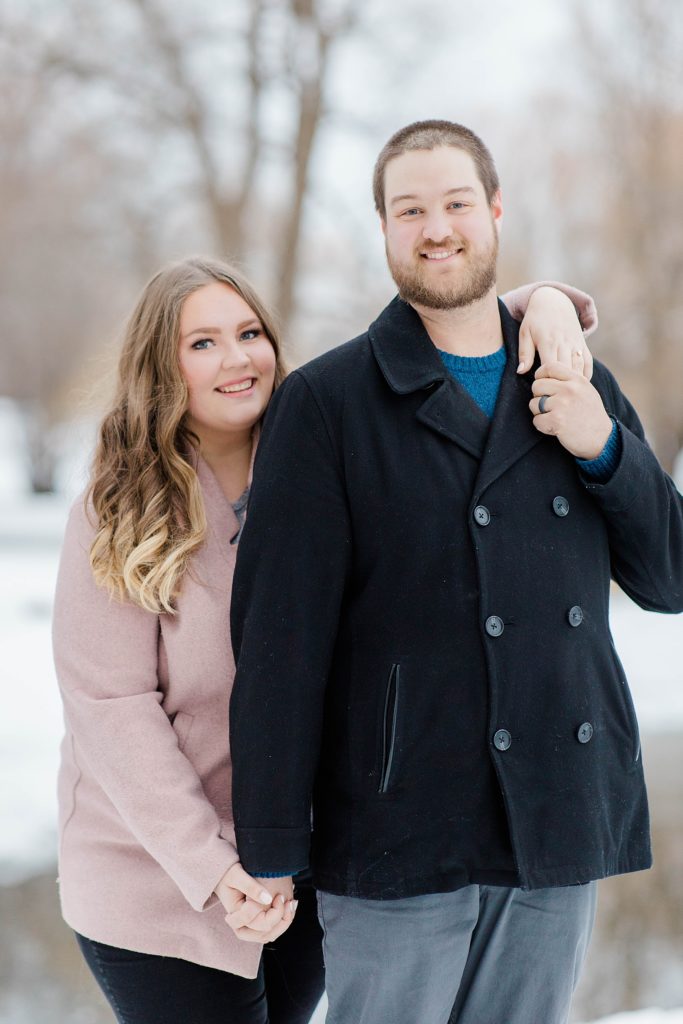engaged couple looking at camera during winter session
