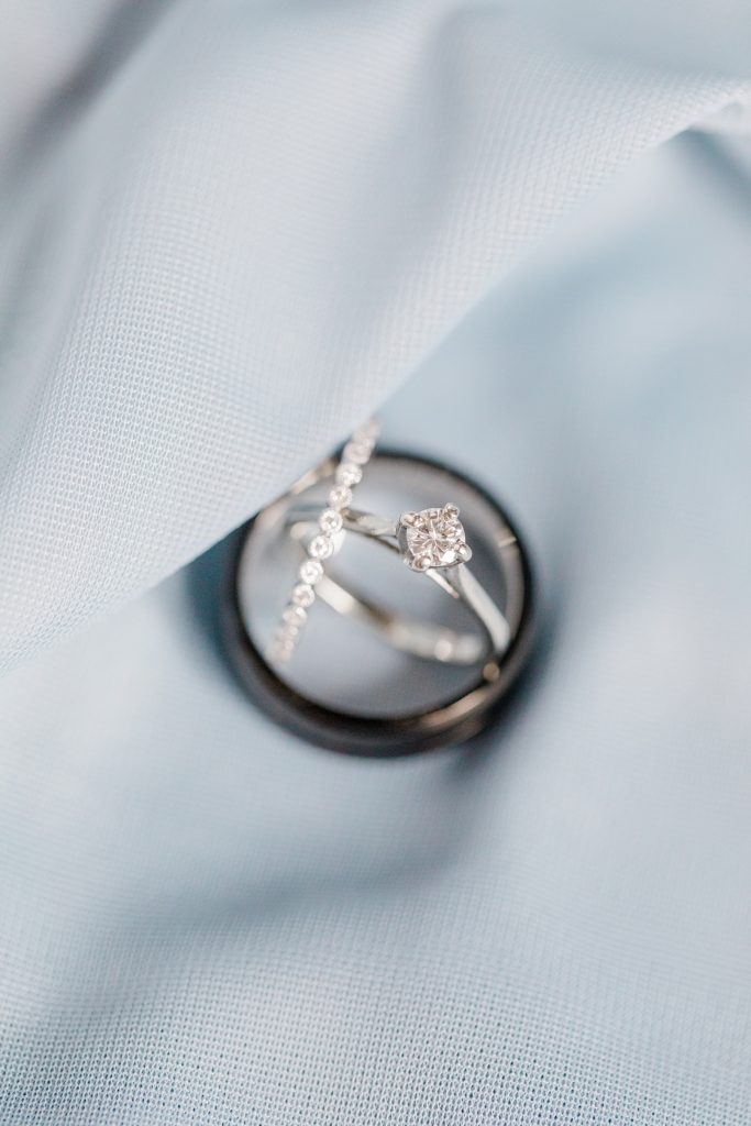 stacked wedding ring photo with bridesmaids dress as the background for carleton golf and yacht club wedding