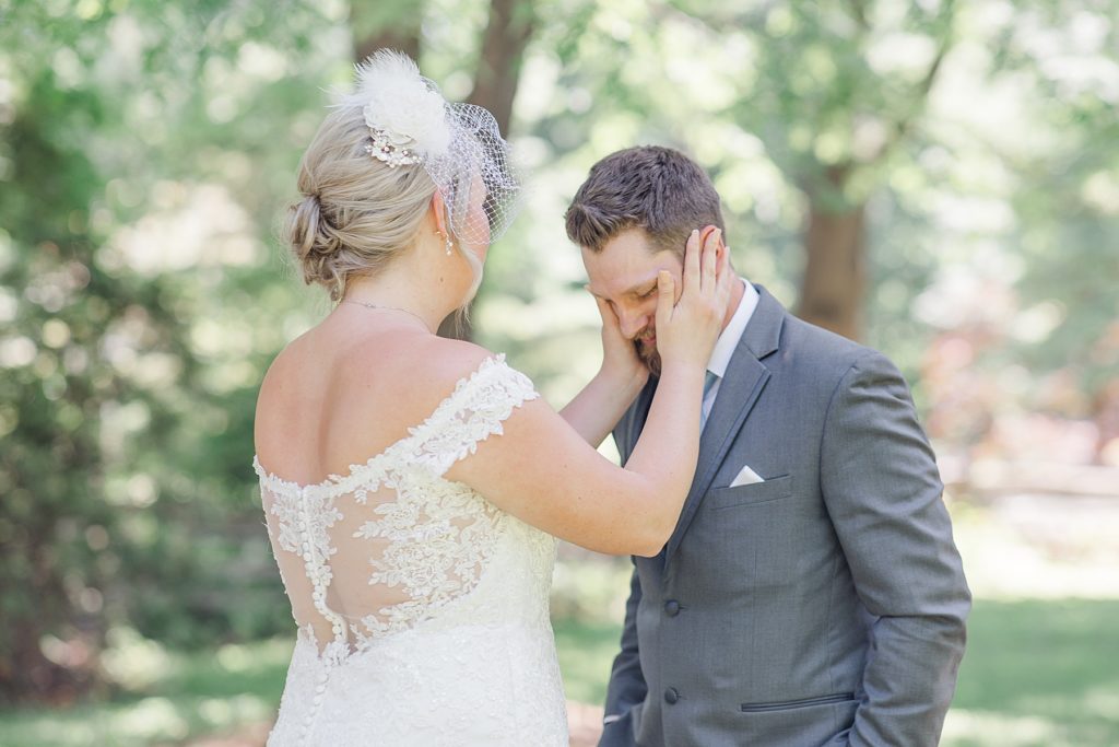 groom is tearing up as he sees his bride for the first time during their first look