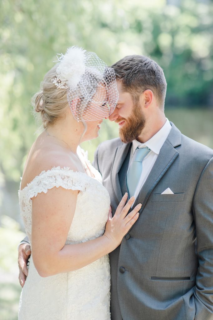 bride and groom forehead to forehead during their formal photos with brittany navin photography