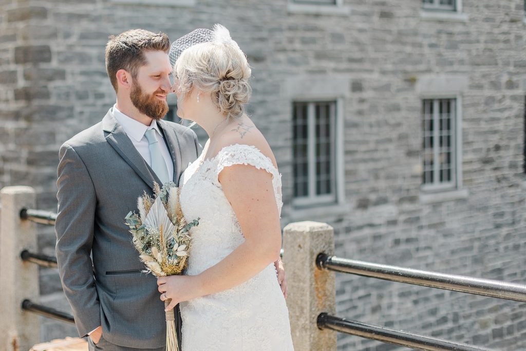 bride and groom nose to nose during formal photos at the watson mill in manotick