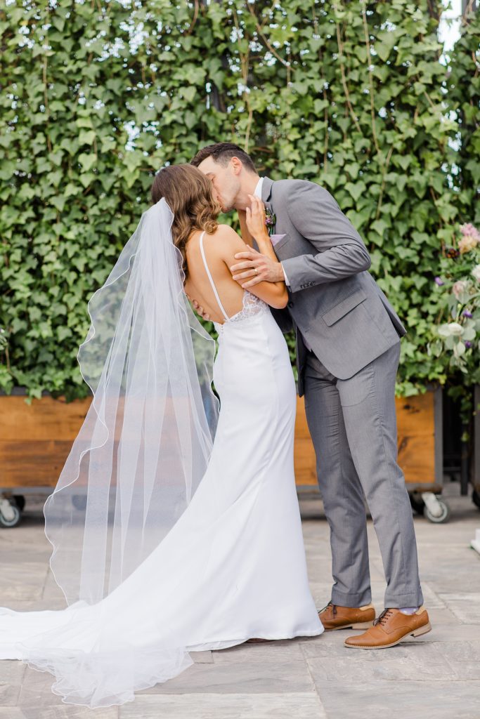 Bride and Groom first kiss during Aquatopia Wedding photographed by Brittany Navin Photography