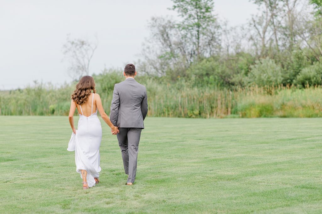 bride and groom walking at Aquatopia wedding photographed by Brittany Navin Photography