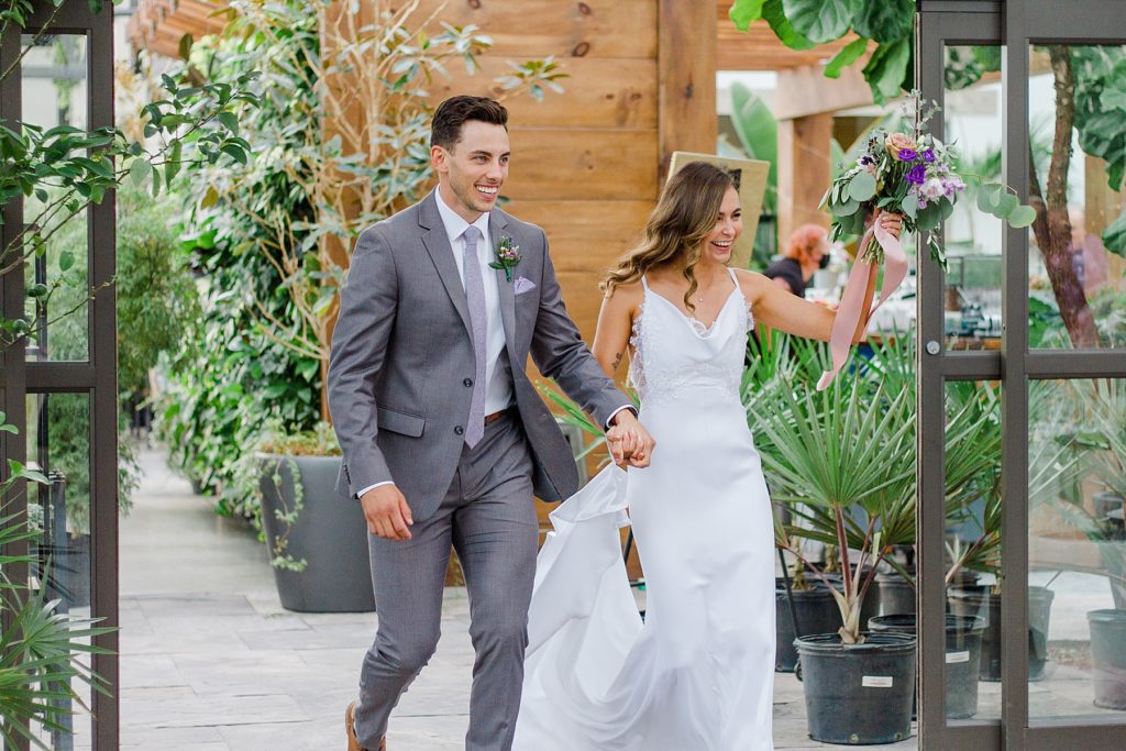 bride and groom entering reception at Aquatopia wedding photographed by Brittany Navin Photography