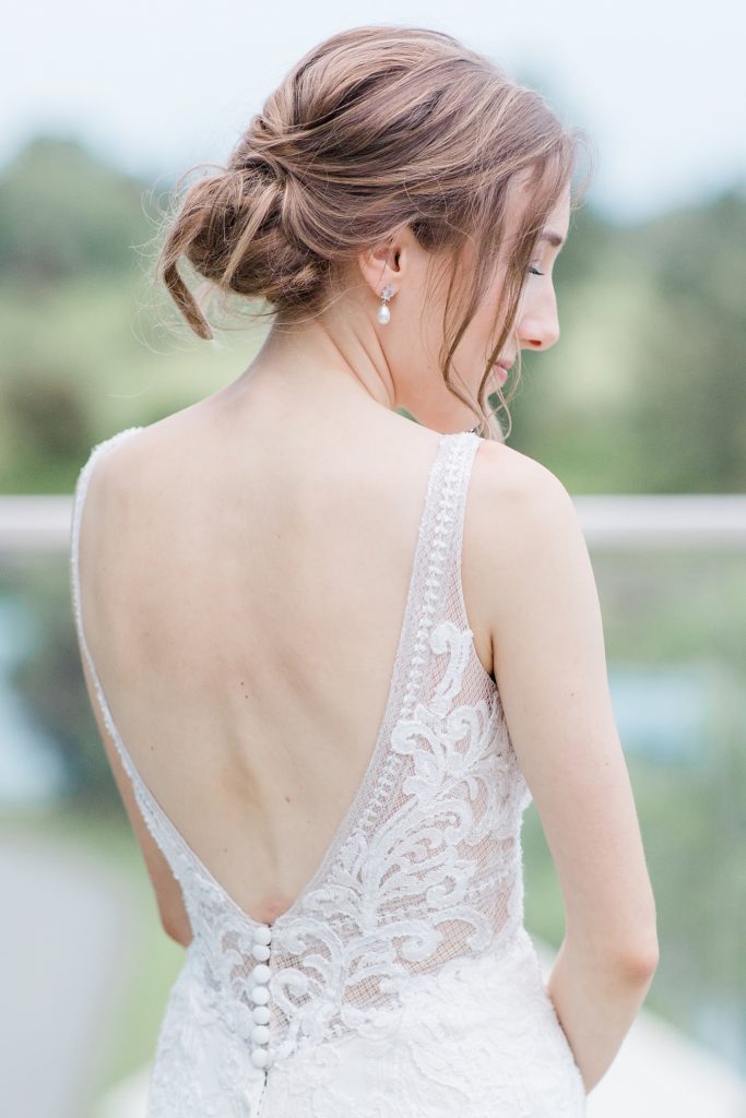 bridal portrait showcasing the back of her dress and bridal hair at Brookstreet Hotel wedding