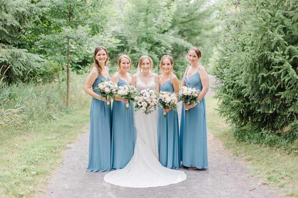 bridesmaids portrait wearing dusty blue dresses at Brookstreet Hotel Wedding in Ottawa with Brittany Navin Photography