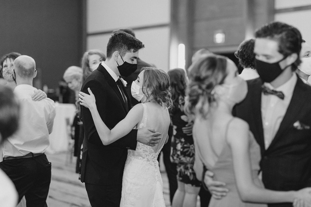 bride and groom and guests are slow dancing during reception at Brookstreet Hotel Wedding in Ottawa with Brittany Navin Photography