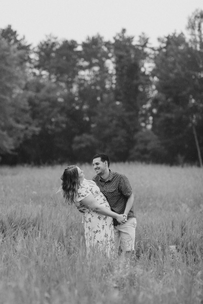 he is dipping her down after dancing at rainy summer Mill of Kintail Engagement session with Brittany Navin Photography in Almonte, ON