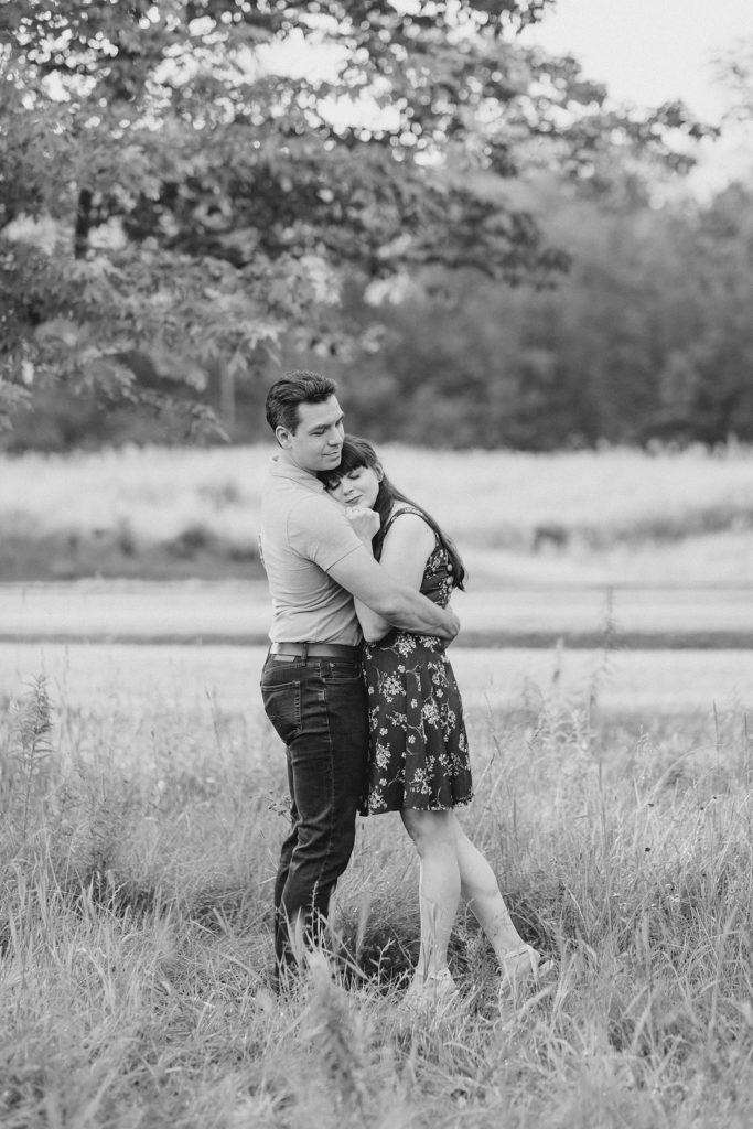 she is resting her head on his chest during engagement in Almonte, ON, at the Mill of Kintail with Brittany Navin Photography