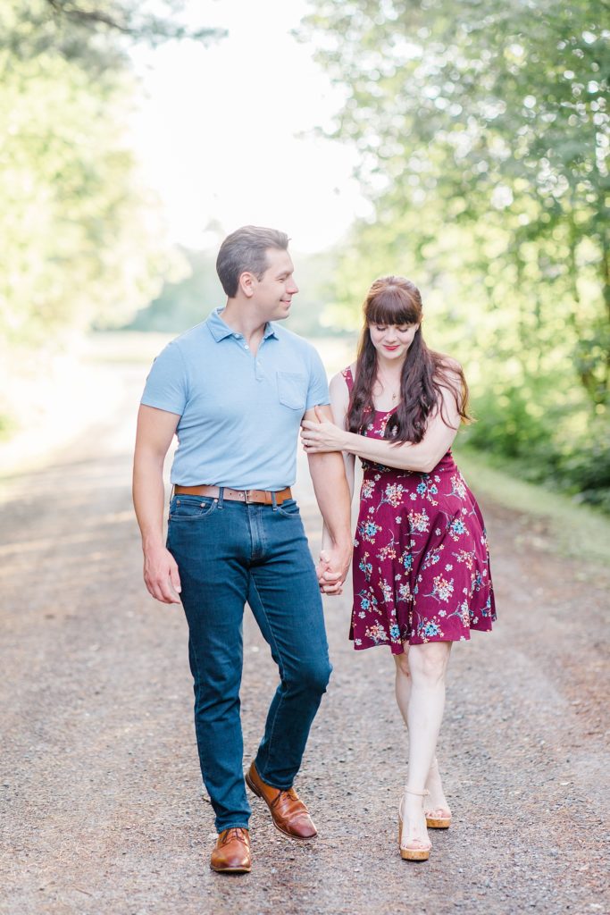 couple walking with their arms linked at engagement in Almonte, ON, at the Mill of Kintail with Brittany Navin Photography