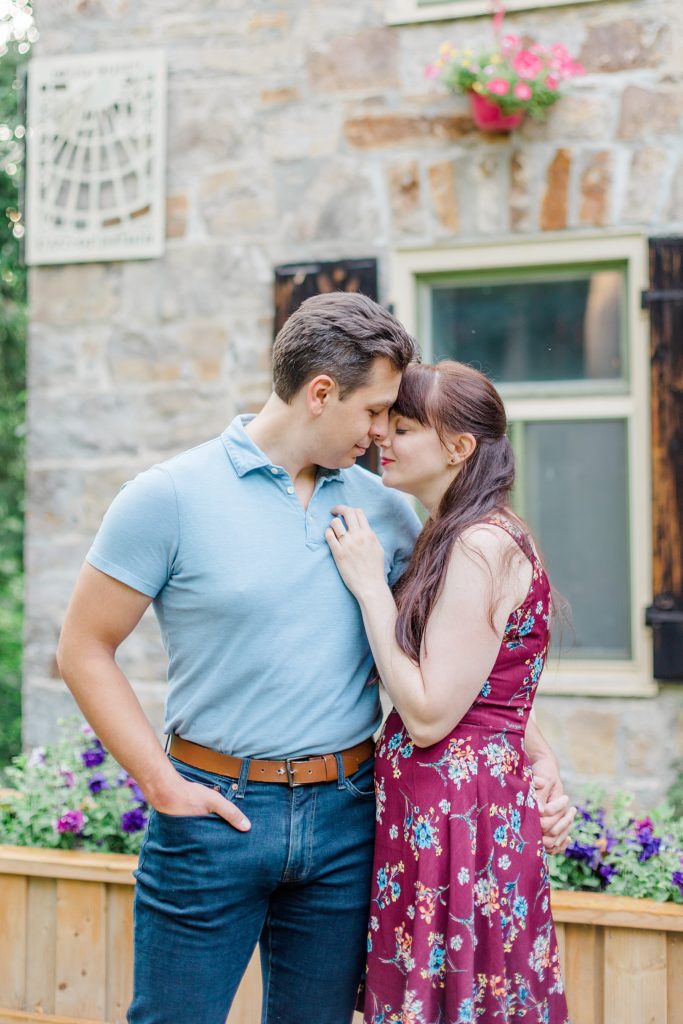 couple enjoying moment in front of stone building during engagement in Almonte, ON, at the Mill of Kintail with Brittany Navin Photography