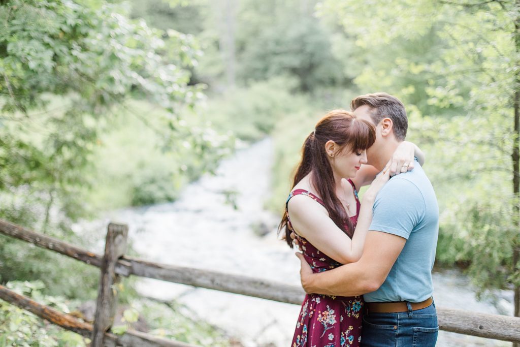 couple enjoying moment by the water during engagement in Almonte, ON, at the Mill of Kintail with Brittany Navin Photography