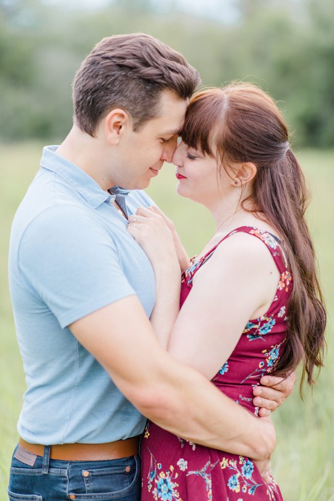 couple forehead to forehead during summer engagement session at Mill of Kintail with Brittany Navin Photography