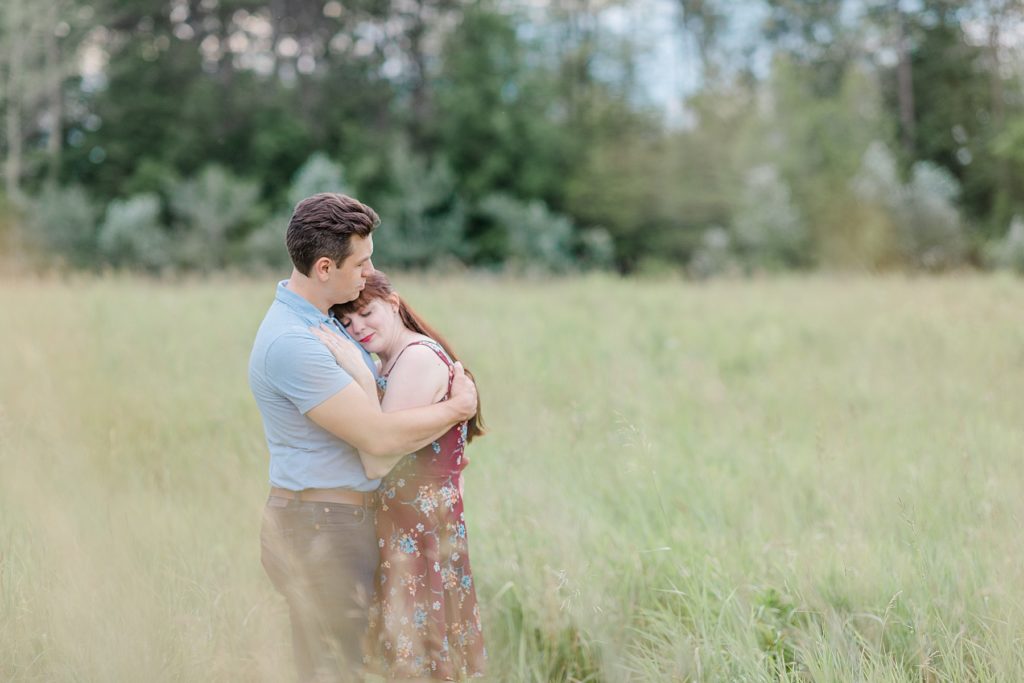 couple enjoying peaceful moment in a field during engagement in Almonte, ON, at the Mill of Kintail with Brittany Navin Photography