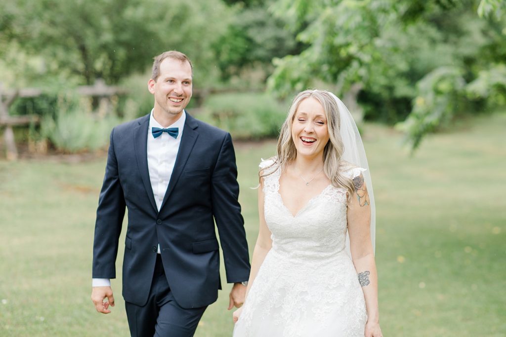 bride and groom smiling as walking at Wedding with Brittany Navin Photography in Almonte, Ontario