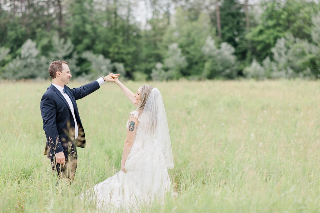 bride and groom dancing in a field at Mill of Kintail Wedding with Brittany Navin Photography in Almonte, Ontario