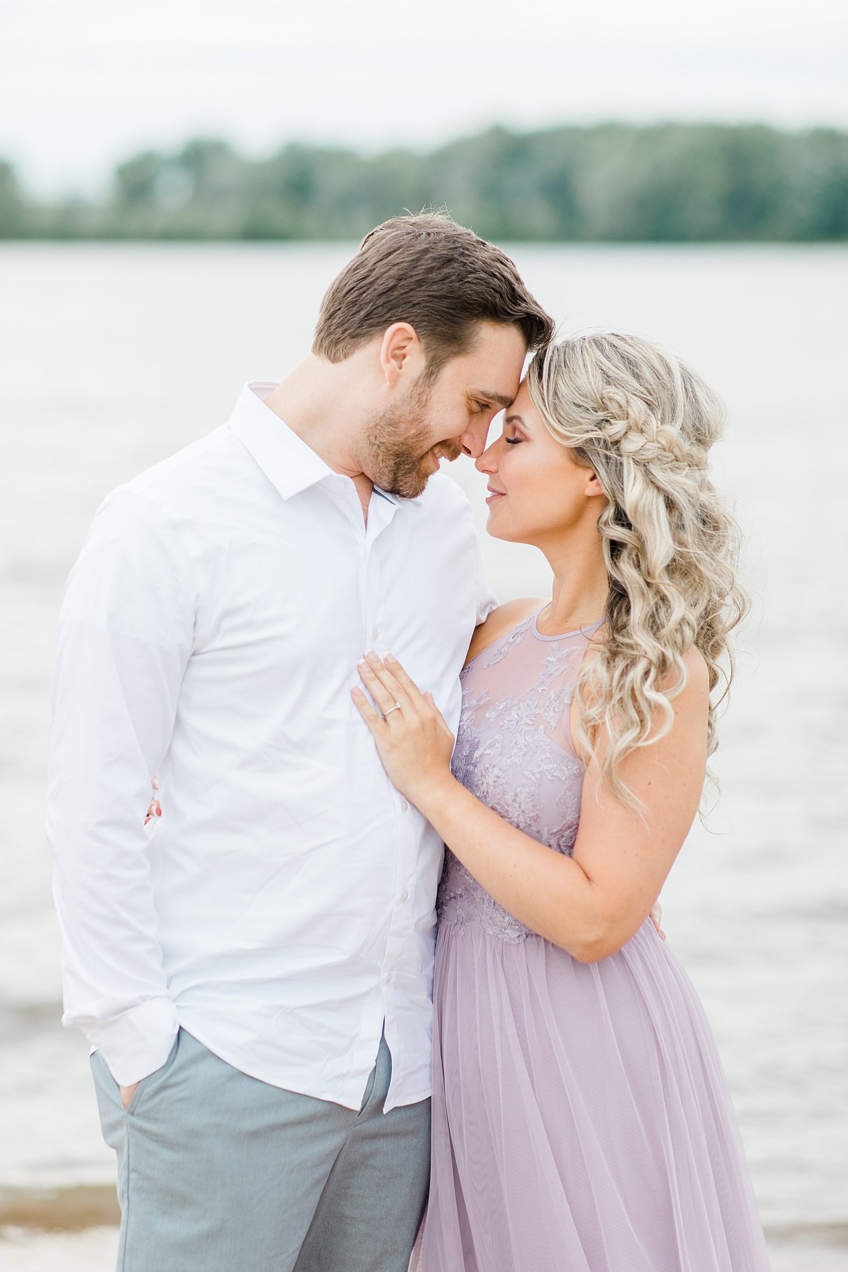 fiance's are forehead to forehead during their ottawa beach engagement photos