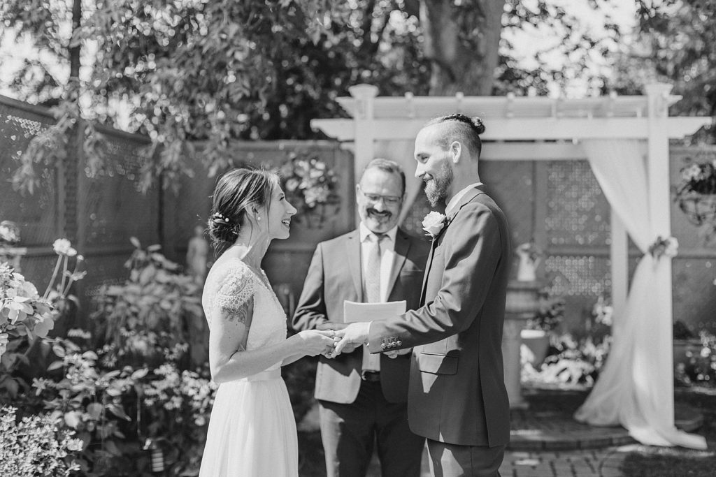 bride and groom exchanging vows At The Schoolhouse wedding in munster ontario photographed by Brittany Navin Photography