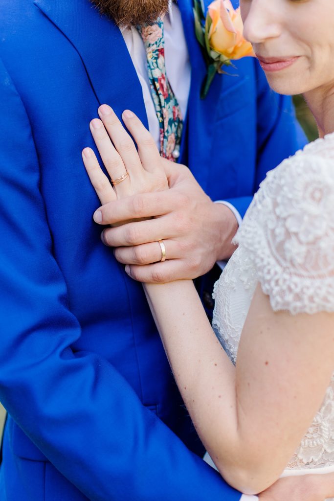 close up of bride and grooms hands with their rings At The Schoolhouse wedding in munster ontario photographed by Brittany Navin Photography