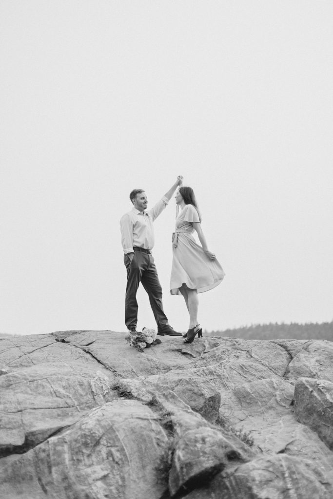 couple dancing on the top of mountain at Eagle's Nest Lookout Engagement in Calabogie, Ontario with Brittany Navin Photography