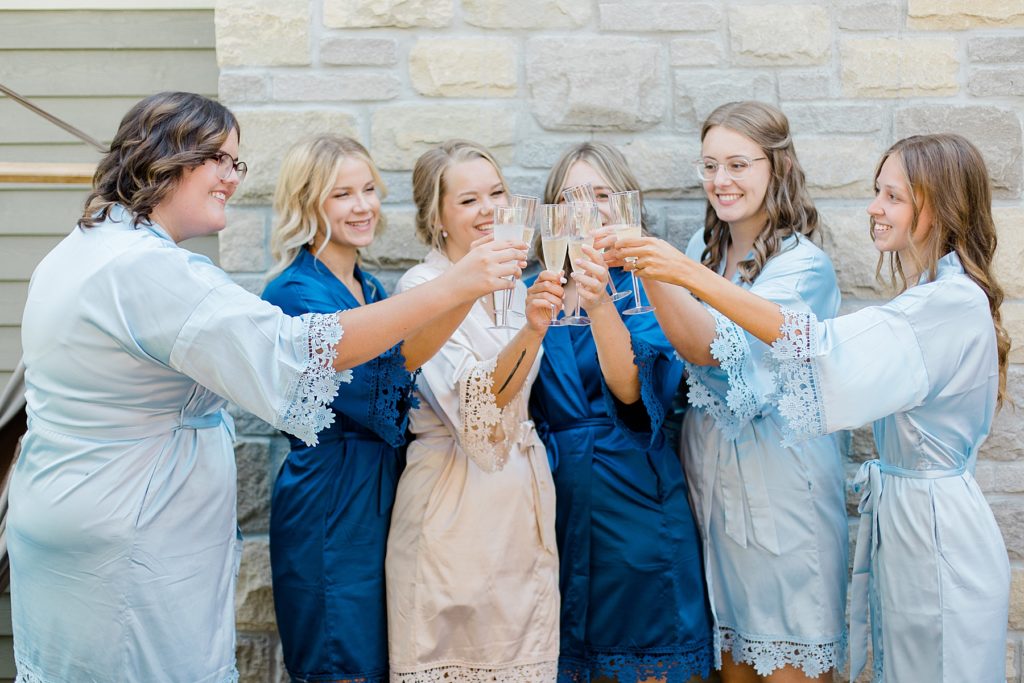 bridal party wearing blue matching robes during getting ready time at Ottawa wedding
