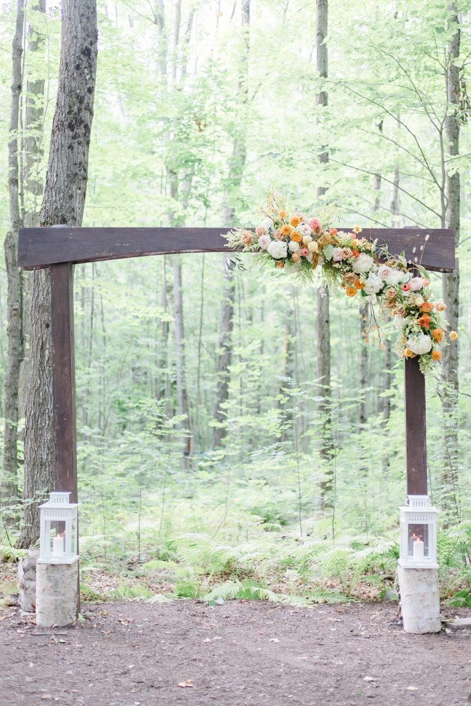 wedding altar arch at Temple's Sugar Bush Wedding Photographed by Brittany Navin. A good example of proper placement of altar for ceremony in backyard