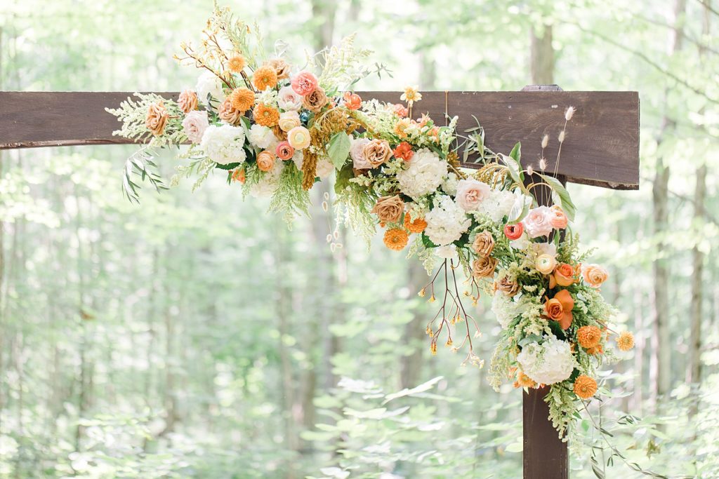 florals on wedding arch done by Pretty Posey at Temple's Sugar Bush Wedding Photographed by Brittany Navin