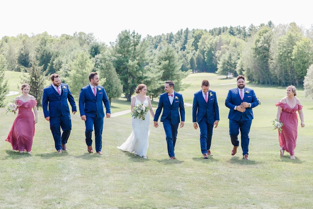 wedding party walking at timber run golf course wedding in Lanark, Ontario photographed by Brittany Navin