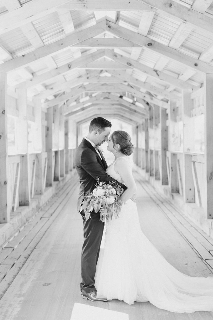 bride and groom portraits in wooden bridge at timber run golf course wedding in Lanark, Ontario photographed by Brittany Navin