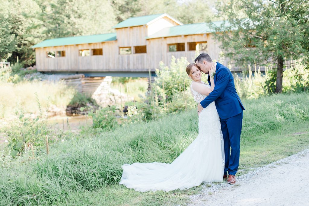 bride and groom portrait with wooden bridge at timber run golf course wedding in Lanark, Ontario photographed by Brittany Navin