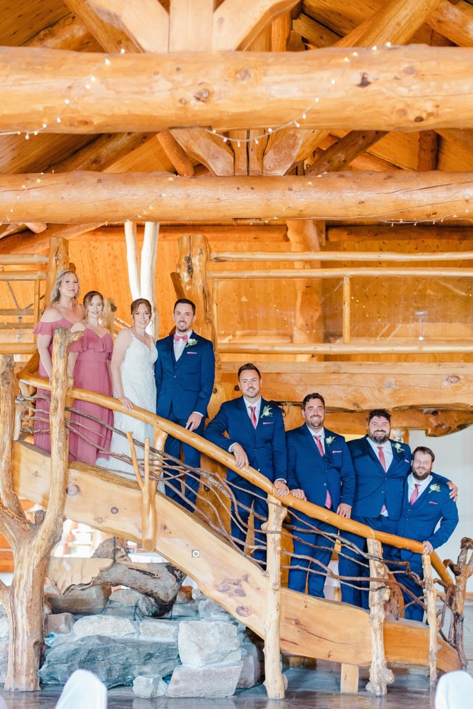 wedding party along the stairs inside at timber run golf course wedding in Lanark, Ontario photographed by Brittany Navin