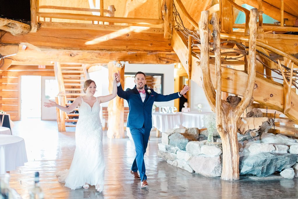 bride and groom grand entrance at timber run golf course wedding in Lanark, Ontario photographed by Brittany Navin