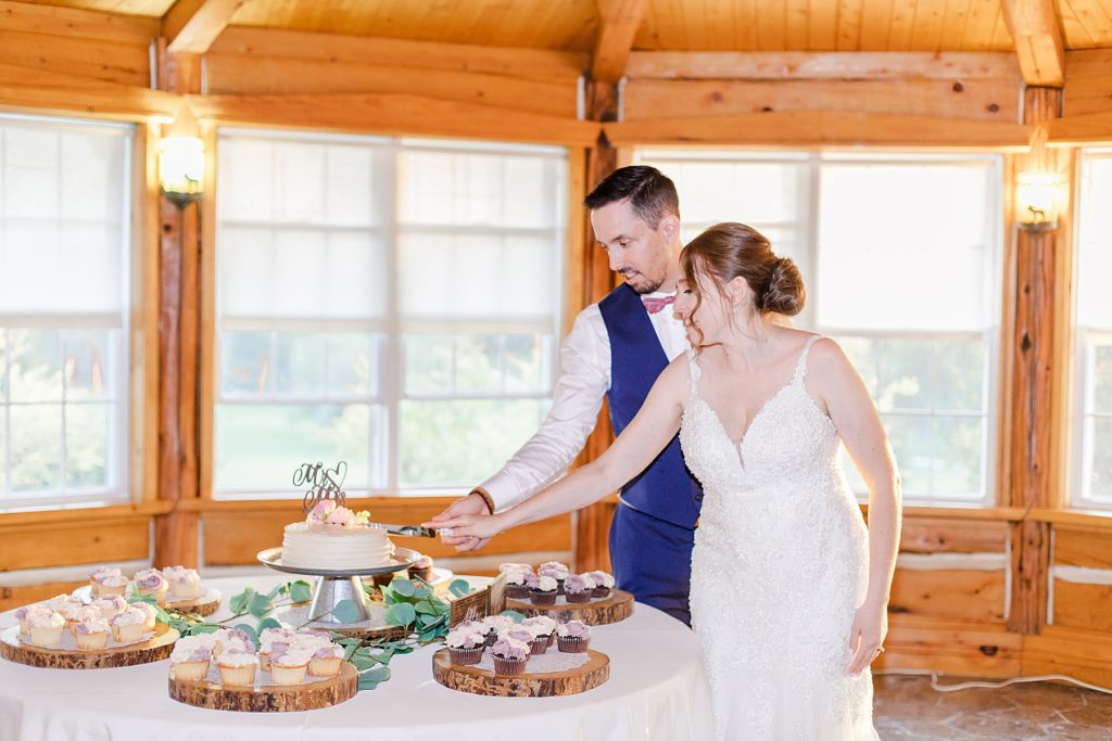 bride and groom cutting cake at timber run golf course wedding in Lanark, Ontario photographed by Brittany Navin