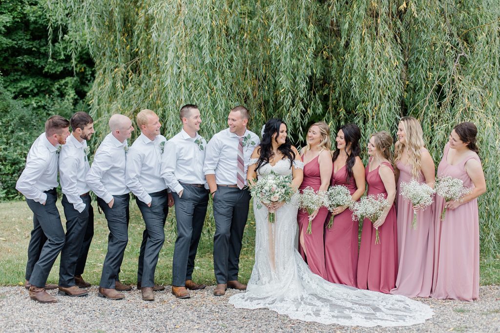 full wedding party with bridesmaids wearing two shades of pink at Adelina Barn Wedding Photographed By Brittany Navin Photography