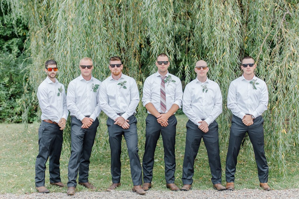 groom and groomsmen wearing white and grey at Adelina Barn Wedding Photographed By Brittany Navin Photography