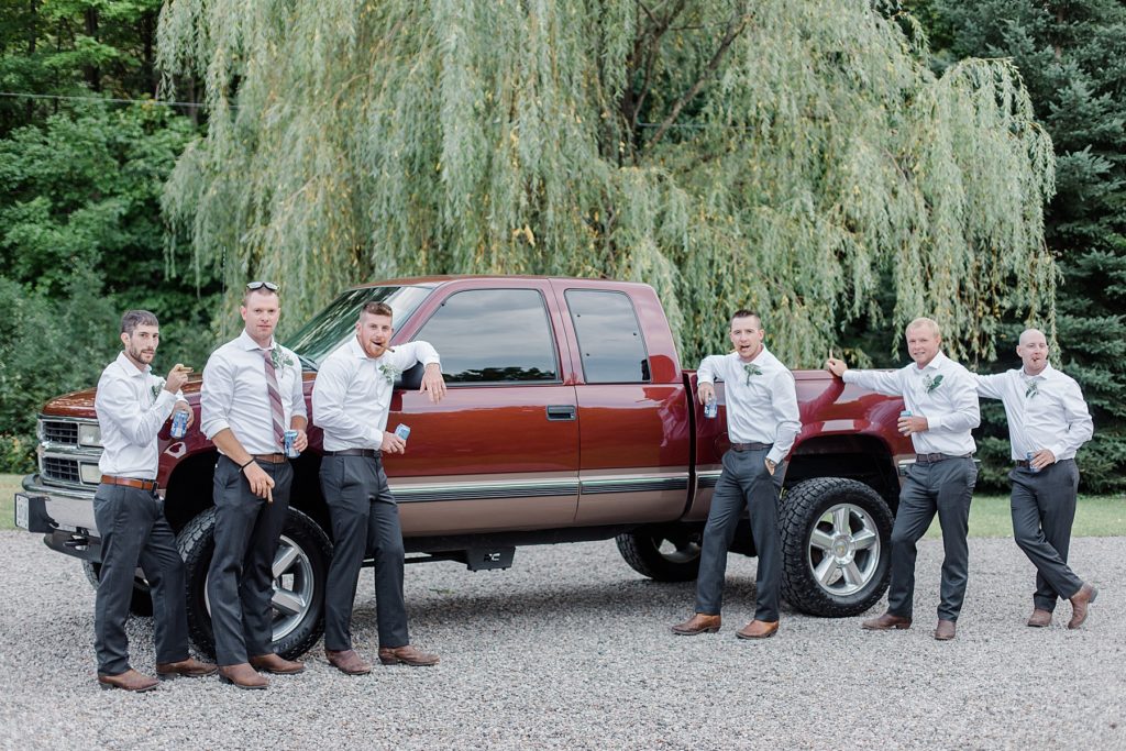 groom and groomsmen by their truck at Adelina Barn Wedding Photographed By Brittany Navin Photography