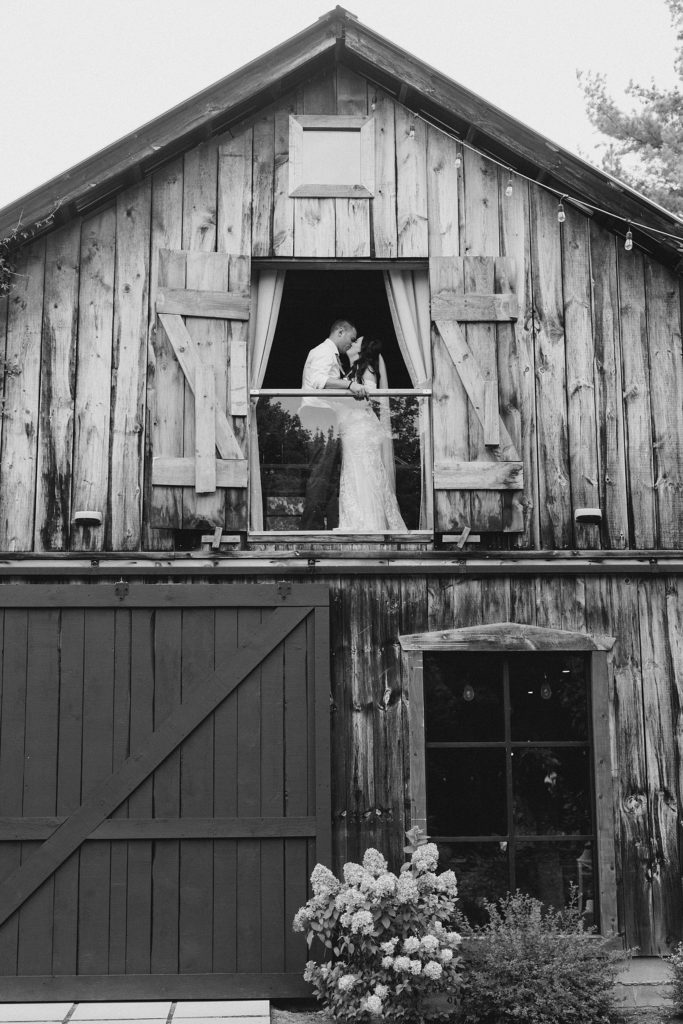 bride and groom up in the barn loft at Adelina Barn Wedding Photographed By Brittany Navin Photography