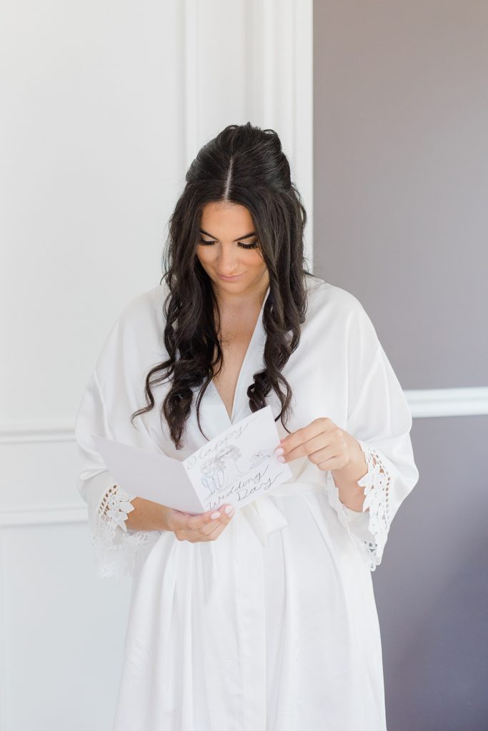 bride reading card from groom at Grand Hotel in Carleton Place Photographed by Brittany Navin Photography