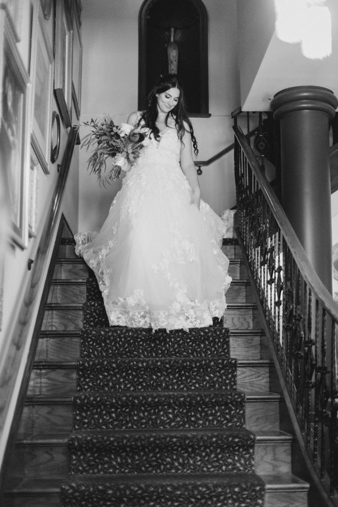 bride coming down the stairs at Grand Hotel in Carleton Place Photographed by Brittany Navin Photography