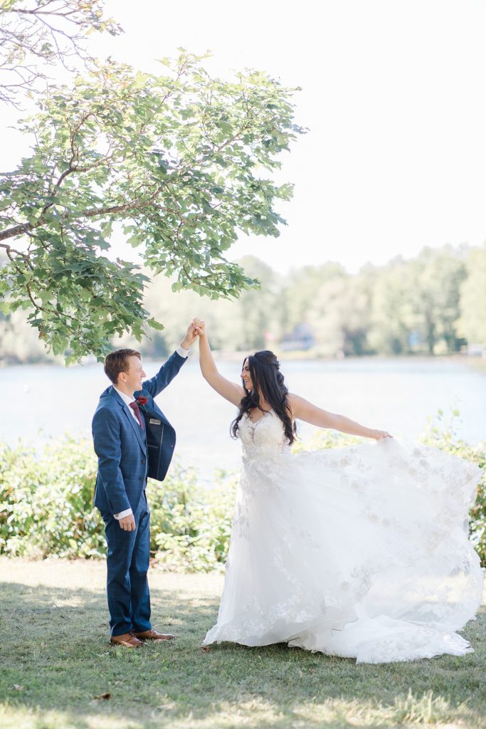 bride and groom twirling at Riverside Park Wedding in Carleton Place photographed by Brittany Navin Photography