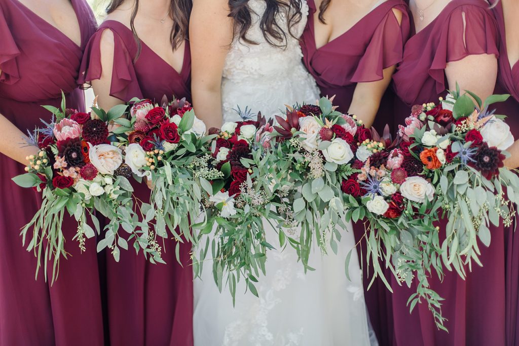 florals from ramsay creek and burgundy bridal party dresses at Riverside Park Wedding in Carleton Place photographed by Brittany Navin Photography